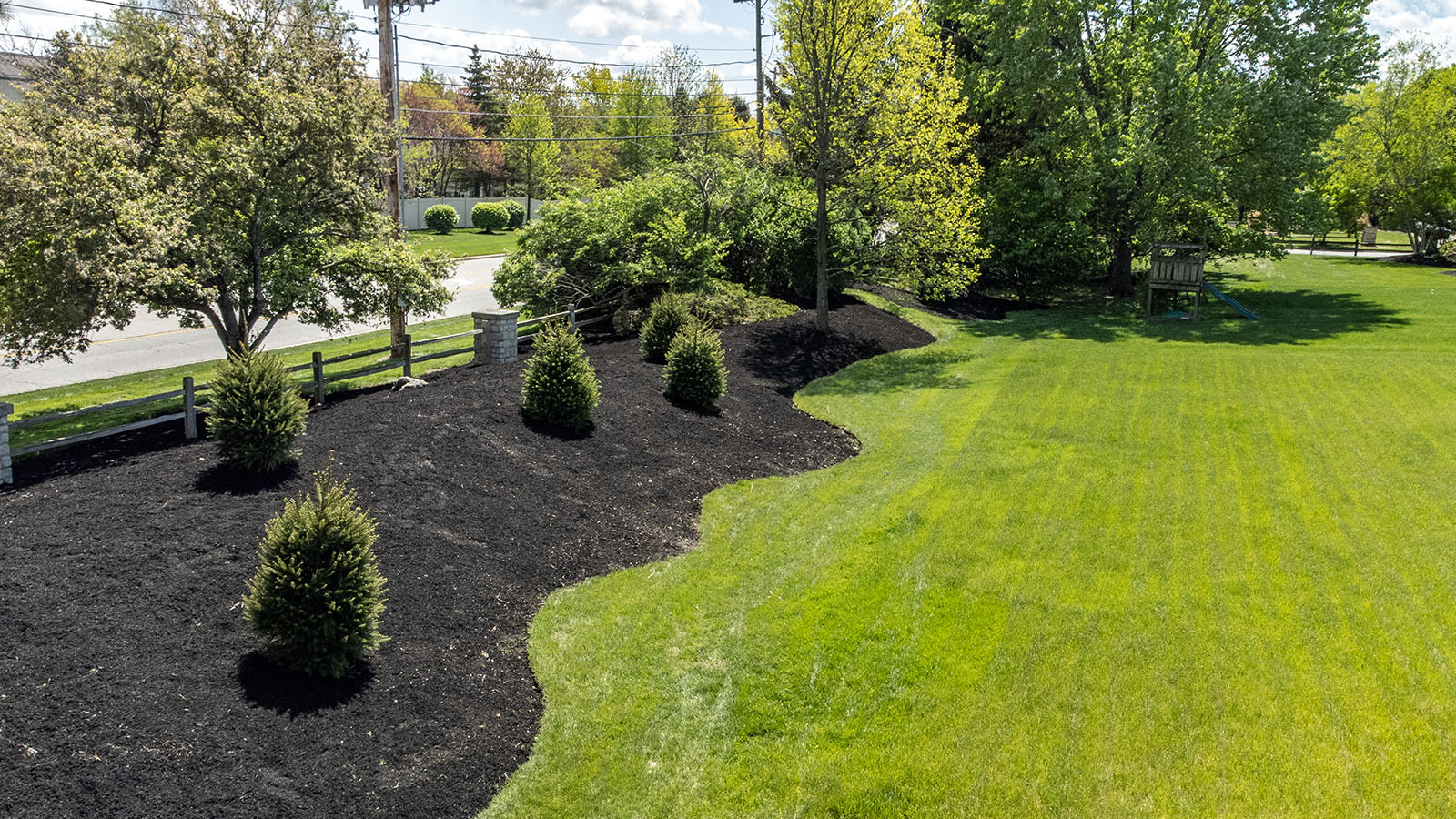 Freshly mowed lawn with clean, sharp edges along a sidewalk showing professional turf maintenance in Central Ohio.