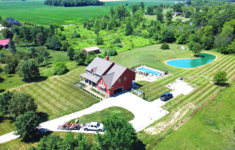 Professional lawn care service featuring a zero-turn mower maintaining a large estate property in Central Ohio.